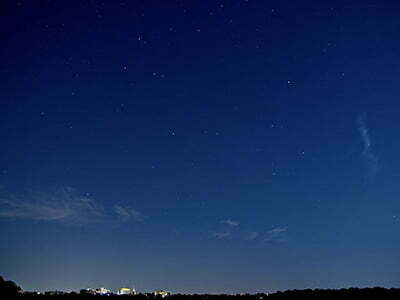 Heldere avondlucht met in de verte te verlichte skyline van Kerkrade <p>Door: Tom de Cock</p>